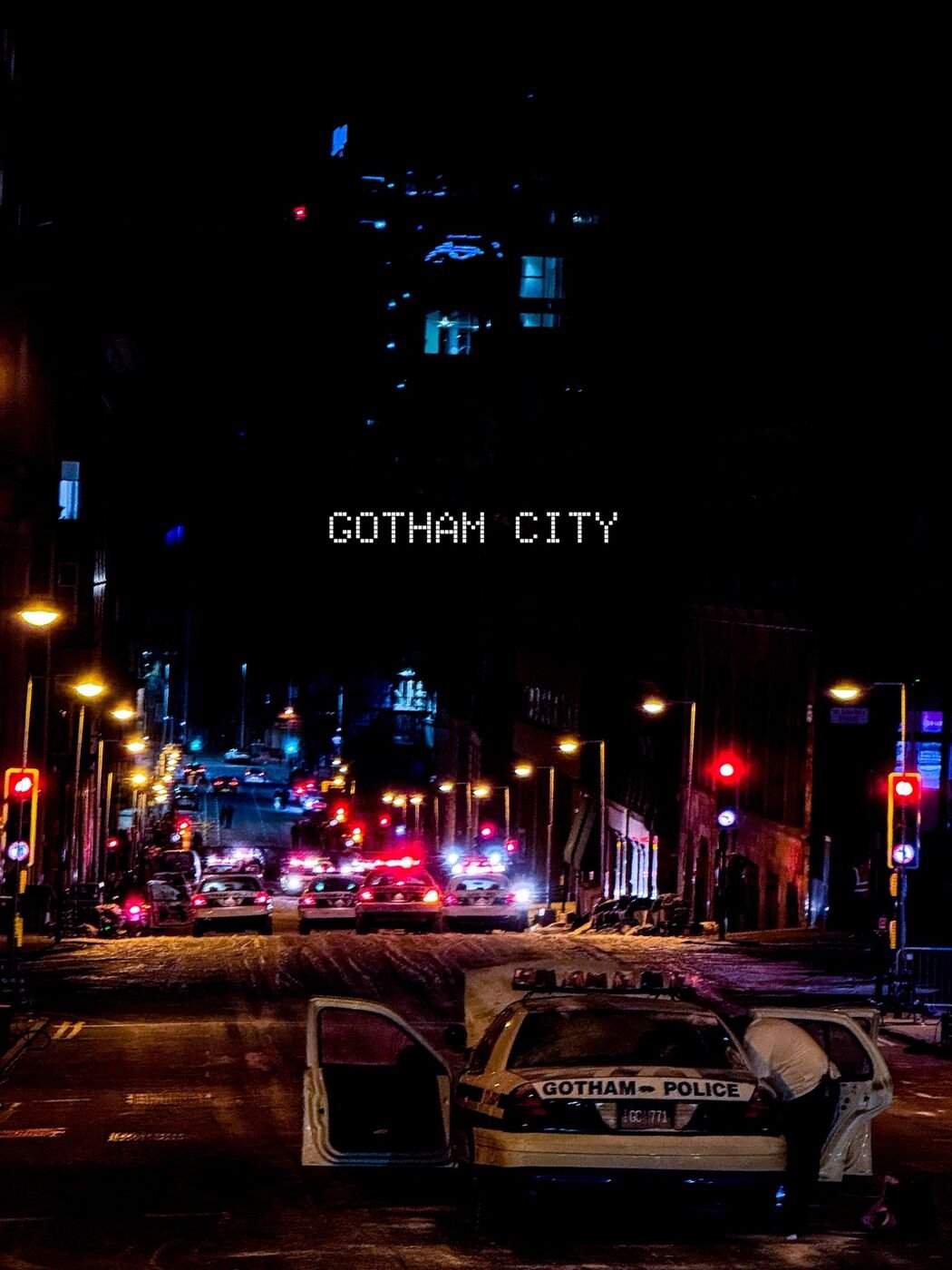 Gotham City title over a Glasgow street at night with police cars and red lights